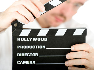 businessman with a clapperboard isolated on white background