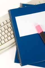 Blue school textbook and computer keyboard