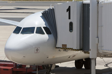 Airplane at an Airport With Passenger Gangway In Position