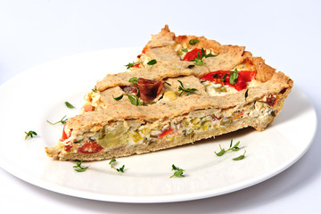 A slice of vegetable tart with tomatoes and prosciutto