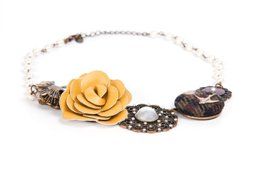 Necklace with leather, fabric and metal details isolated on whit