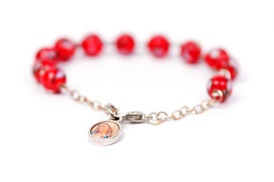Red bracelet with medalion containing the picture of Mary Magdal