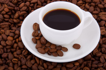 Cup with coffee, costing on coffee grain