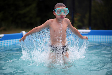 Kid jumping in a swimming pool