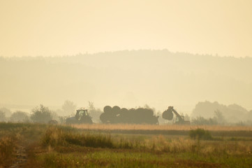 Fototapeta premium Loading Bales at Dawn