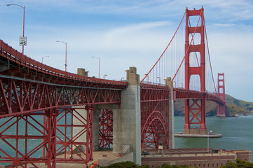 Golden Gate Bridge on blue sky with white clouds