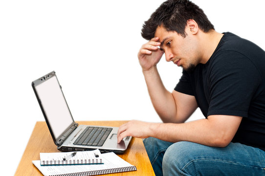 frustrated guy using his laptop isolated on white
