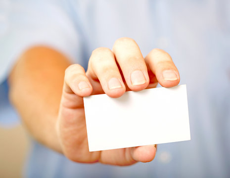 Man holding visiting card - Powered by Adobe
