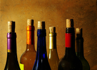 assorted wine bottles with corks