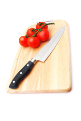 cutting board with a knife and tomato
