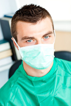 Young male surgeon wearing scrups and a mask
