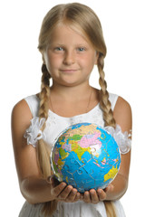 The girl holds the globe collected from puzzle in hands. Selecti