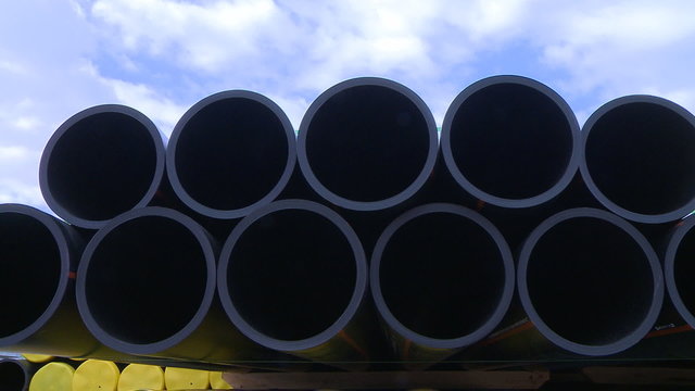 Pipes stacked in construction site dolly shot