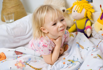little girl in bed touching throat - obrazy, fototapety, plakaty