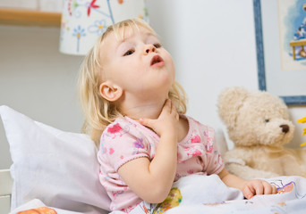 little girl in bed touching throat © mbt_studio