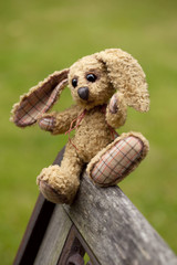 small rabbit soft toy sitting in an iron bench, Author's work wi