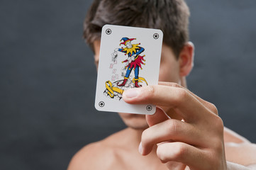 Joker in a hand with man