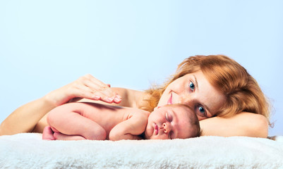 Fototapeta na wymiar Young happy mother with newborn baby