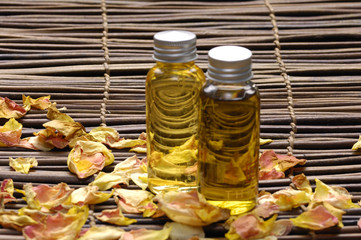 Two bottle of essential oil with rose petals