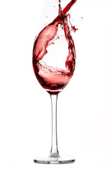 Red wine splashing out of wine glass
