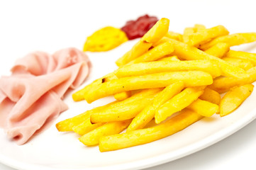 closeup of french fries with ham, ketchup and mustard