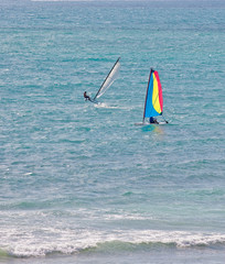 Two Windsurfers Riding the Surf