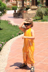 a little girl in yellow Pareo
