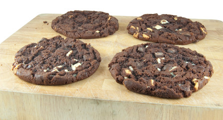 four large cookies on board isolated on white