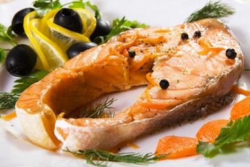 Salmon served with olives and lemon