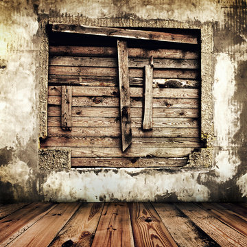 room in an old house with boarded up window