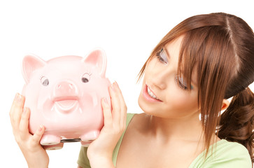 lovely teenage girl with piggy bank