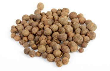 Detail shot of a pile of black peppercorns. All isolated