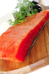 smoked salmon on wooden plate with white cheese