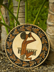 Native art work of shield & palms from South Pacific Islands.