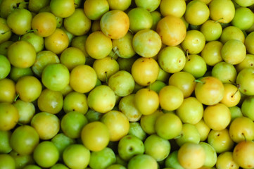 Green plums on a market