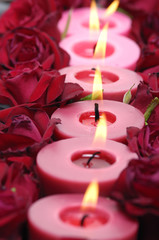 A row of red candle and rose