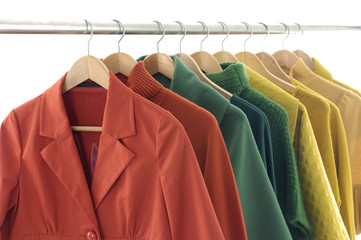 Row of colorful female coat on hangers