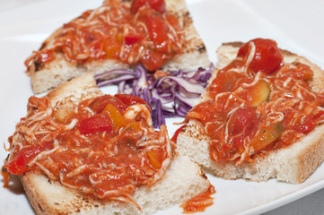 Toasted bread with a Ice fish and tomatoe sauce