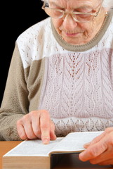 Elderly woman studying the Bible