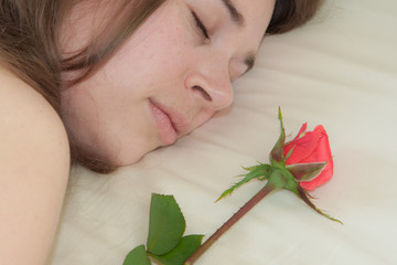 Young woman sleeping and a rose - 24446996