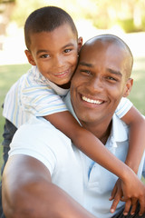 Portrait of Happy Father and Son In Park