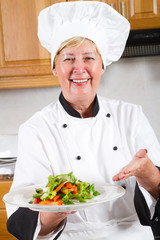 happy female chef presenting salad