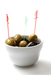 black and green olives in white cup. isolated object
