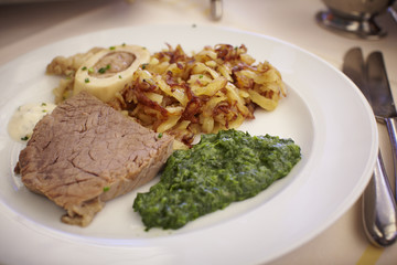 Country meal of soup beef, bone marrow, potato and spinach.