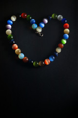 Vertical cat's eye necklace in shape of heart on black