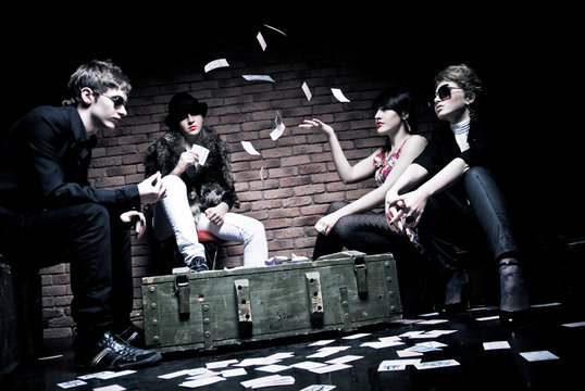 Young people playing poker underground