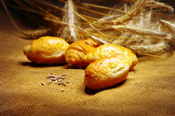 Vintage Styled still-life with cruissant and wheat ears