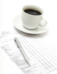 White cup of cappuccino on paper table numbers.