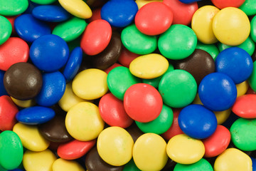 Fototapeta na wymiar background of multicolored candy coated chocolate sweets
