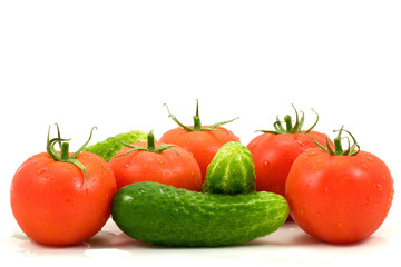 fresh tomatoes and cucumbers isolated on white background
